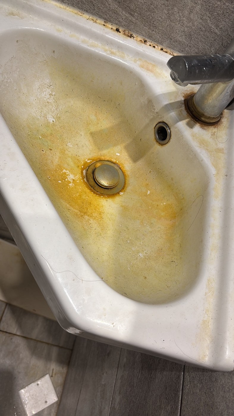 Dirty bathroom sink before cleaning